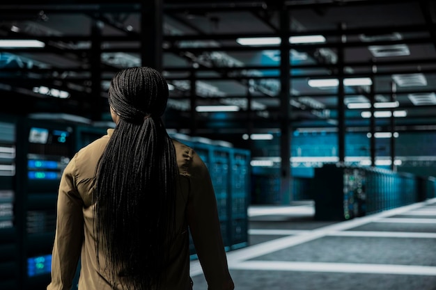Engineer walking between storage infrastructure rows in a data centre